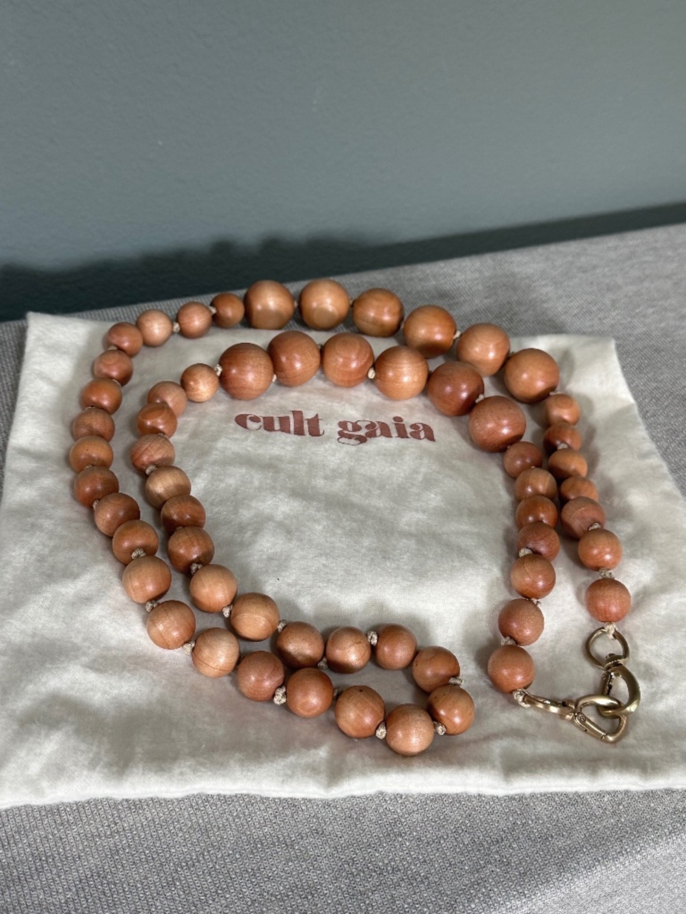 cult gaia wooden bead necklace in warm brown with gold clasp